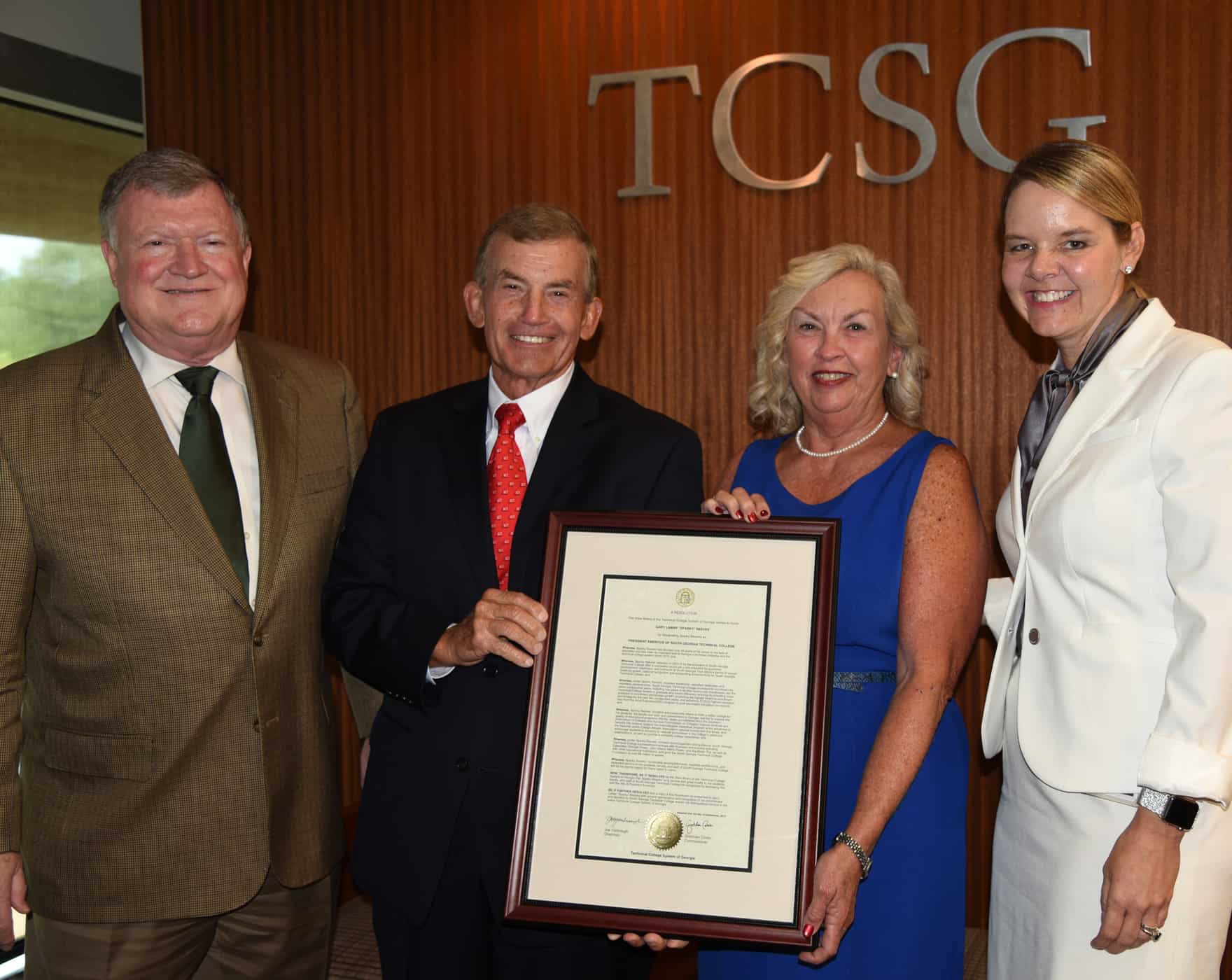 President Sparky Reeves and Allene Reeves accept a plaque from the TCSG Commissioner.