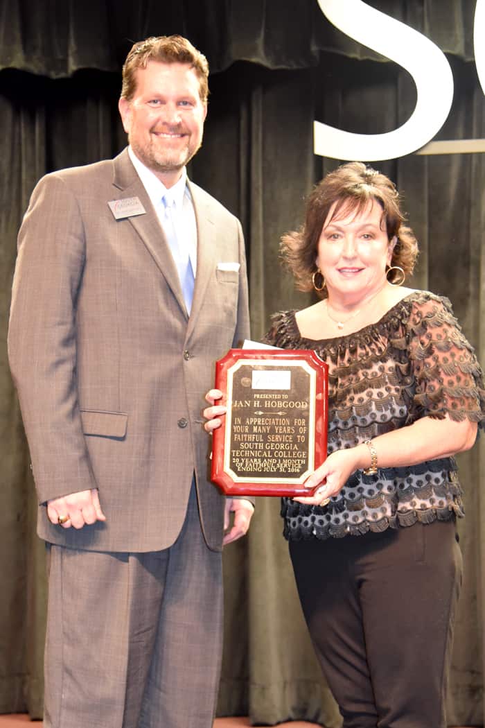 South Georgia Technical College President Dr. John Watford is shown above (l) presenting Jan Hobgood with a plaque for over 20 years of service.