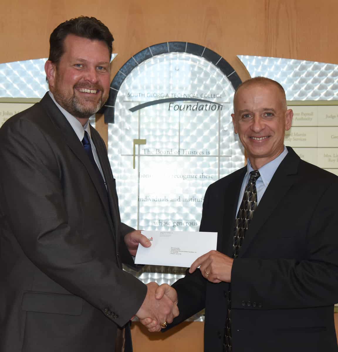 South Georgia Technical College President Dr. John Watford is shown above (l) thanking Georgia Power Area Manager Jem Morris (r) for the donation to the SGTC Foundation.