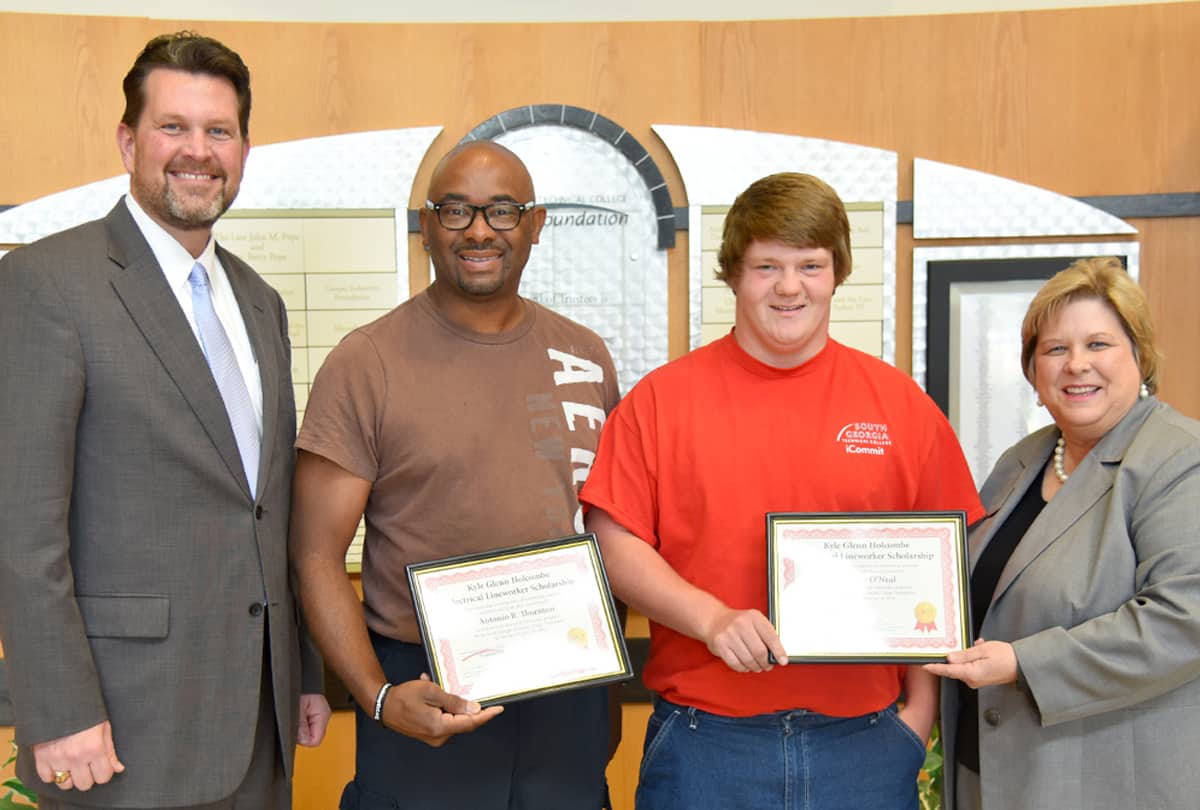 South Georgia Technical College President Dr. John Watford is shown above (l to r) with Electrical Lineworker students and the Kyle Glenn Holcombe Scholarship recipients Antonio B. Thornton and Harvey O’Neal. Also shown presenting them with scholarship certificates is South Georgia Technical College Vice President of Institutional Advancement and Executive Director of the Foundation Su Ann Bird.