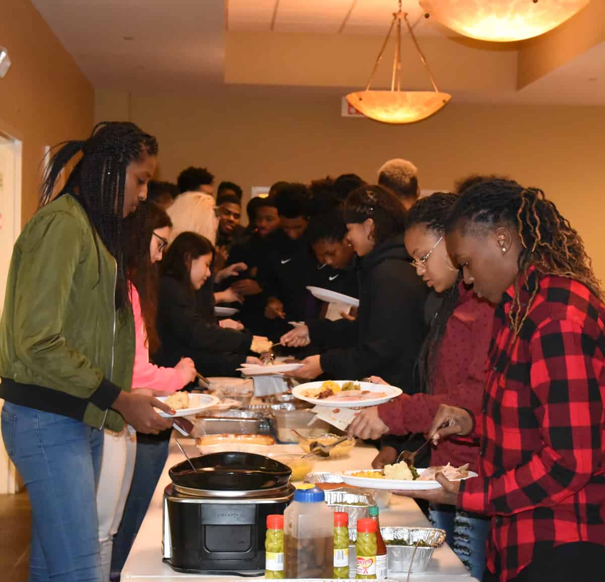 SGTC Lady Jets and Jet are shown above helping themselves to a Thanksgiving Dinner provided by the Jets Booster Club.