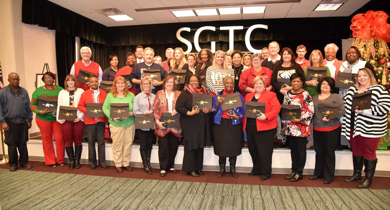 SGTC employees are shown above holding up their service awards. SGTC employees were recognized for 1,222 years of service at the South Georgia Technical College annual employee Christmas luncheon.