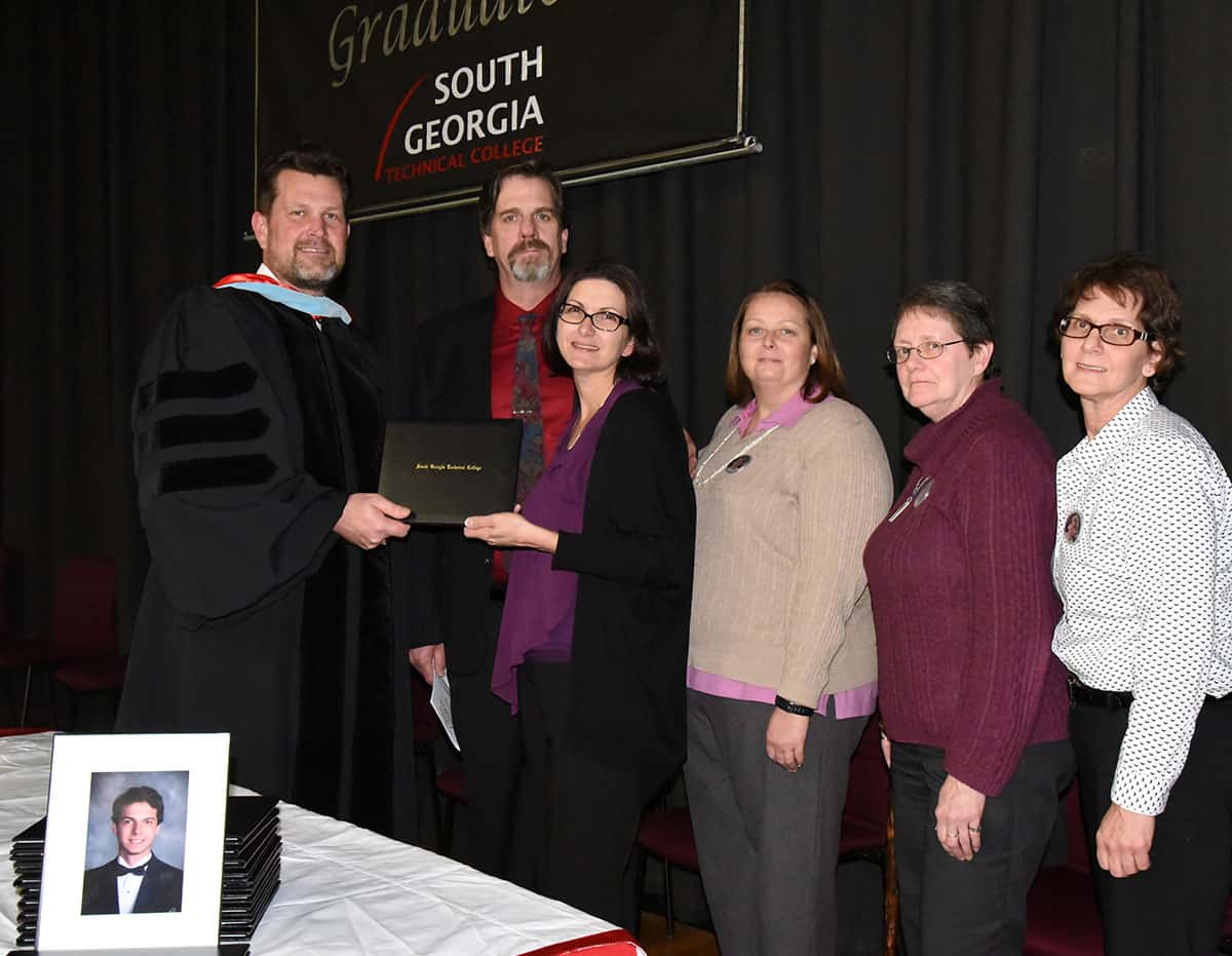 SGTC President Dr. John Watford is shown above presenting a diploma to Joy Anderson, mother of Motorsports student Jacob Anderson, who passed away due to injuries in an automobile accident. Also shown are Scott Baker, Beth Anderson, Nance Seifert, and Lorraine Smalley.