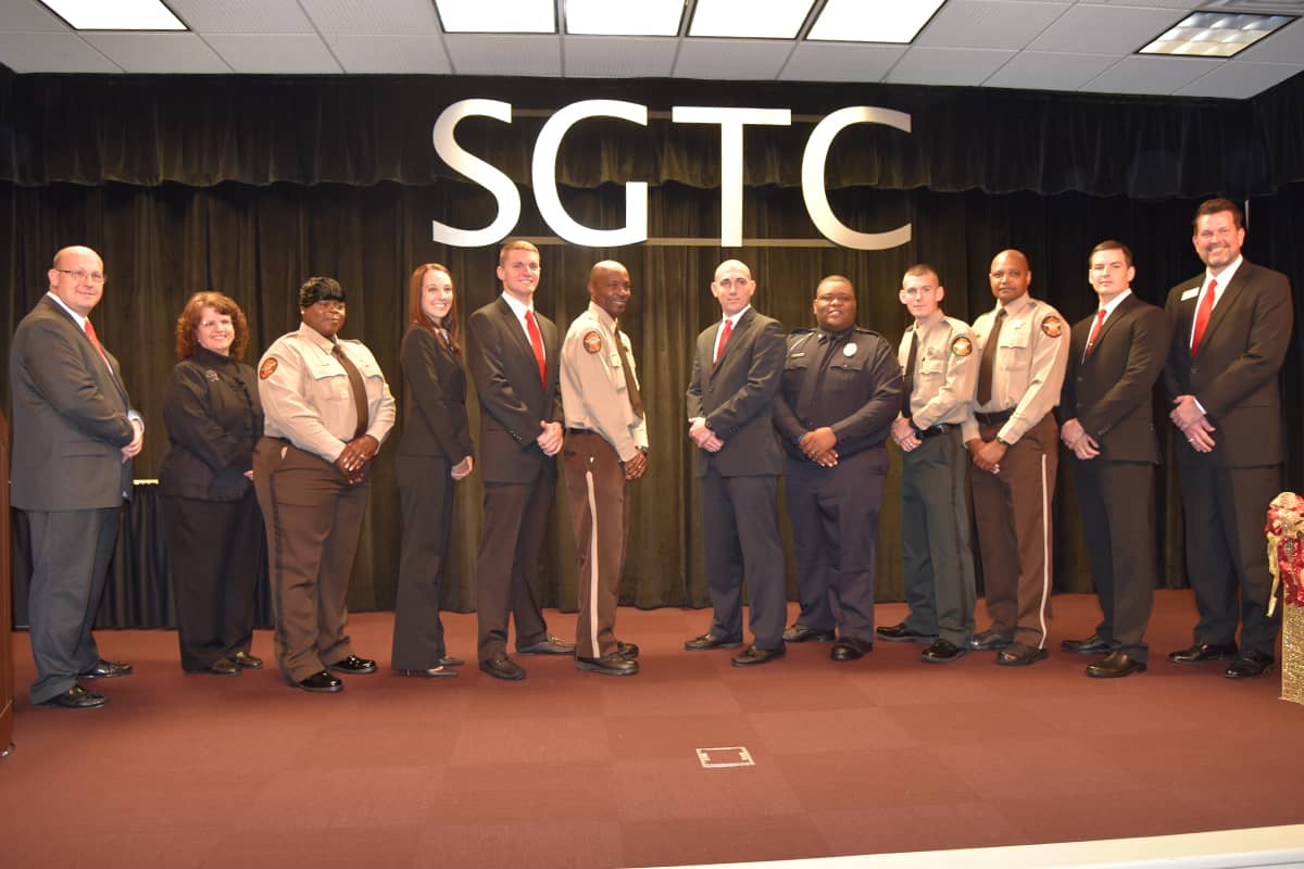 SGTC Law Enforcement Academy graduates are pictured with SGTC President Dr. John Watford (far right), LEA Program Director Brett Murray (far left), and Dean for Academic Affairs Vanessa Wall (second from left). Those graduates, from left to right, are Kendranna Walker, Tiffeni Fox, Austin Smith, David Sims, Jr.; Joshua Wayne Taylor; Calvin Hodge, Jr.; Wesley Phillip Atchley, Robert Gene Fairbanks, and Michael Steven Bentley.