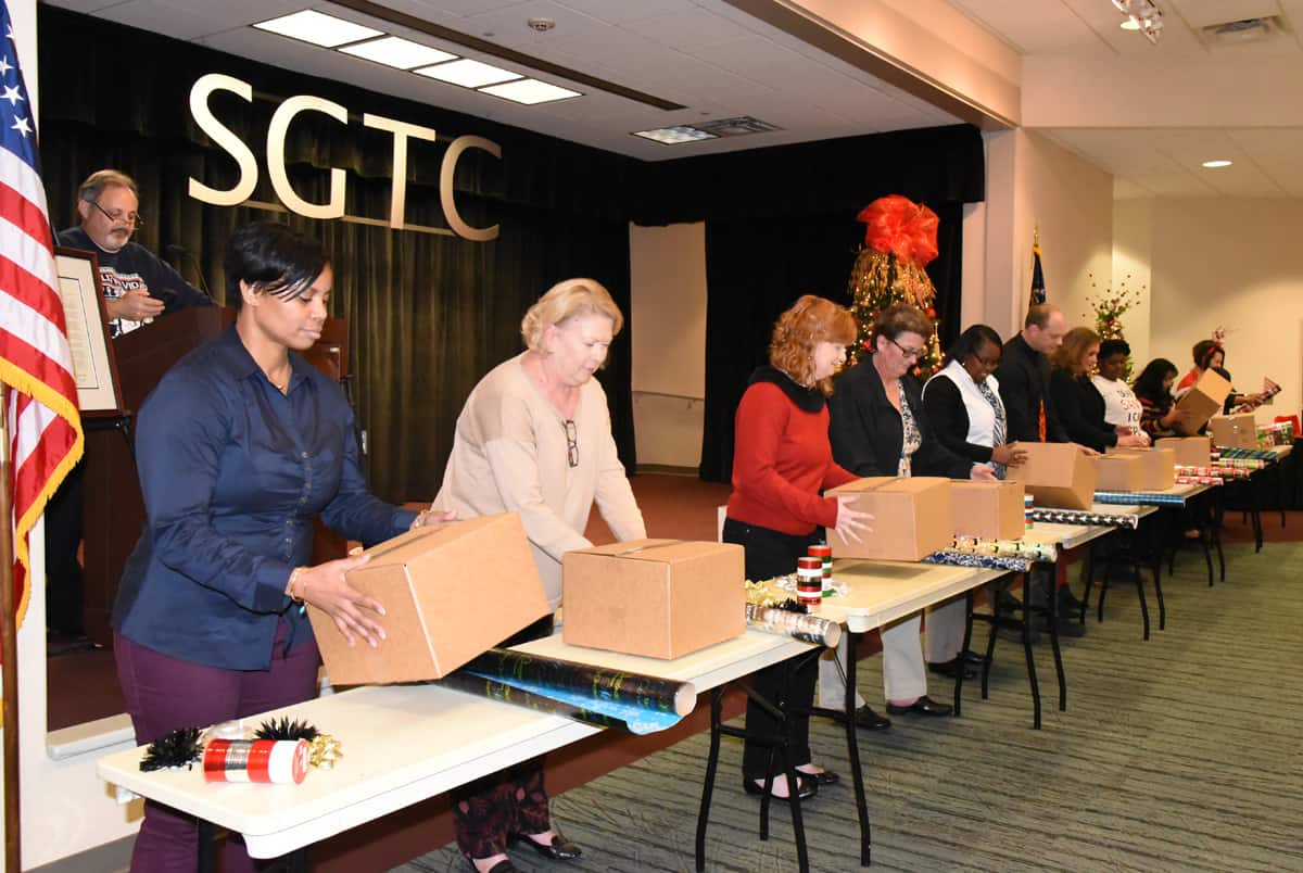SGTC employees are shown above participating in the Christmas present wrapping contest.