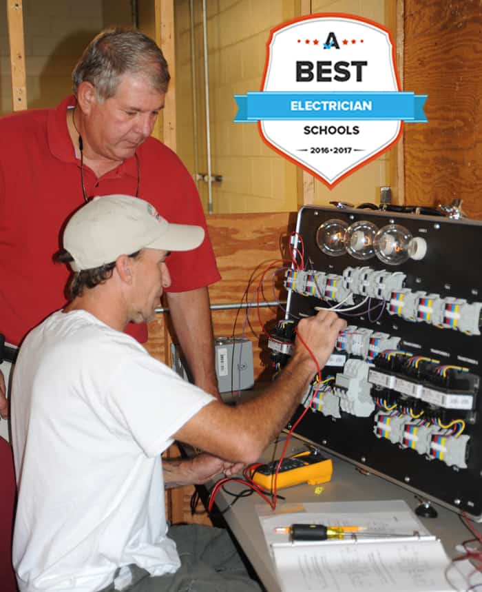 An SGTC Electronics instructor teaches a student on an electrical board.