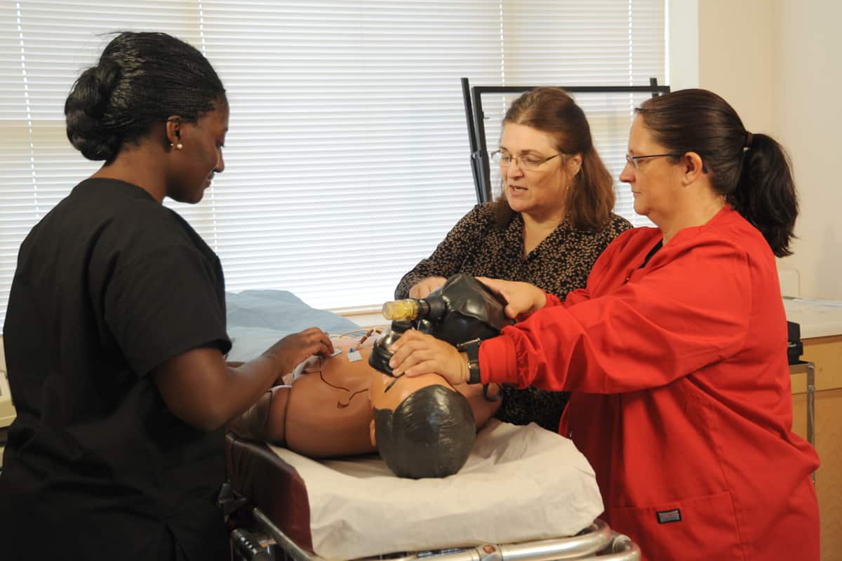 SGTC’s Medical Assisting program was recognized as one of the top medical assistant programs in the nation by Accredited Schools Online recently. Instructor Diana Skipper (second from right) is pictured instructing students in the medical assisting lab on a training mannequin.