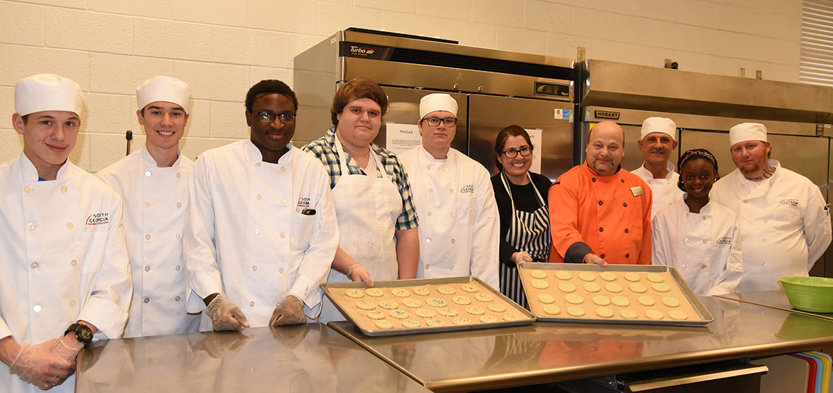 SGTC Culinary Arts students display the cookies they made and baked for the “Night to Shine” event. Shown above (l to r) are: Culinary Arts students Markus Given of Americus; Kyle Biggs of Leslie, Cecil Williams and William Martinez of Americus, Justin Keyser of Maulk, Linda Kent of Montzuma, Instructor Chef “Ricky” Watzlowick, Robert West of Albany, Nykeria Marshall of Americus and Paul McNiel, Jr. of Preston.