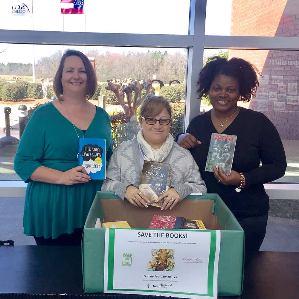 NTHS member Maria Rivera (center) is pictured with NTHS Advisors Kari Bodrey (left) and Katrice Taylor (right) and some of the books that were collected during Book Recycling Week. The books were donated to Keep Crisp Beautiful.