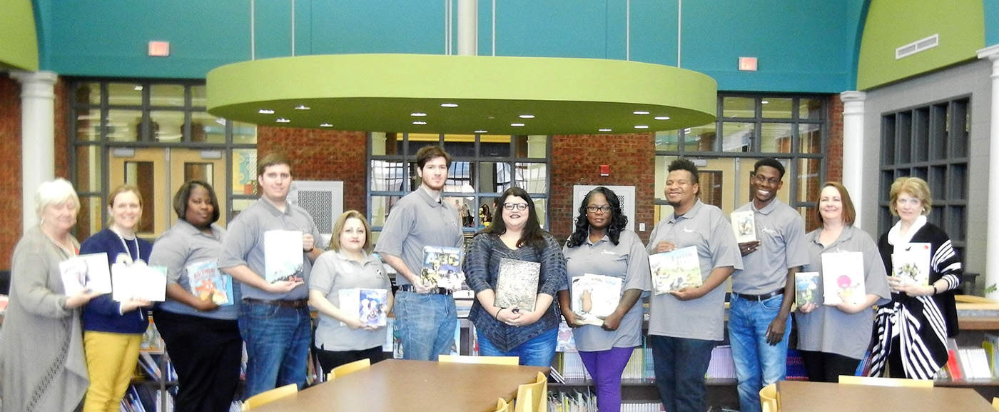 Pictured from left to right are Crisp County Primary School Media Center Specialists Beth Thompson and Kelly Hamilton, NTHS Vice President Valerie Byron, NTHS member Joshua Chappell, NTHS President and State Officer Maria Rivera, NTHS member Dakota Hall, Gina McGahee Odom, daughter of Linda Albritton McGahee; NTHS member Ramona Williams, NTHS member Dontavious Harrell, NTHS Parliamentarian and State Officer Christian Powell, NTHS co-advisor Kari Bodrey, and CCPS Media Center Specialist Beverly Harris.