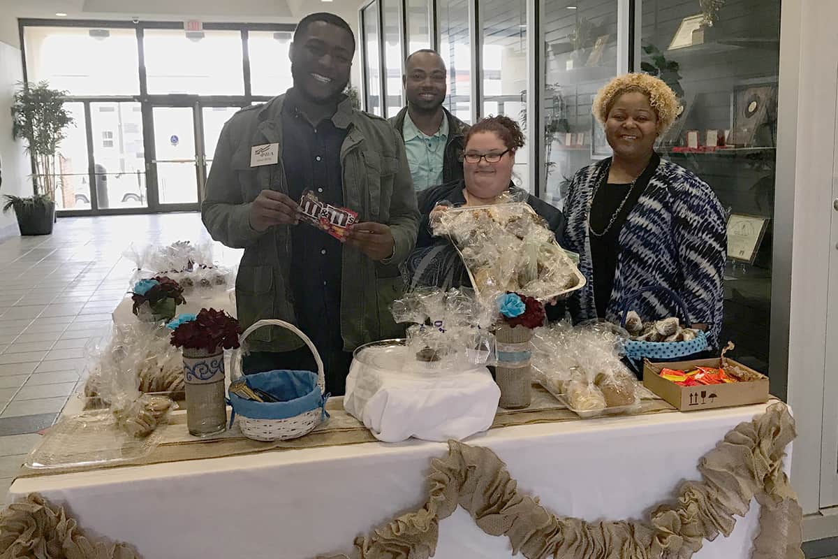 PBL members (from left to right) Jaleun Willis, Racarda Blackmon, and Ashley Halstead are pictured with PBL Advisor Dr. Andrea Oates (far right) at the Pop-Up Bakery Shop that PBL organized to help raise funds for March of Dimes.