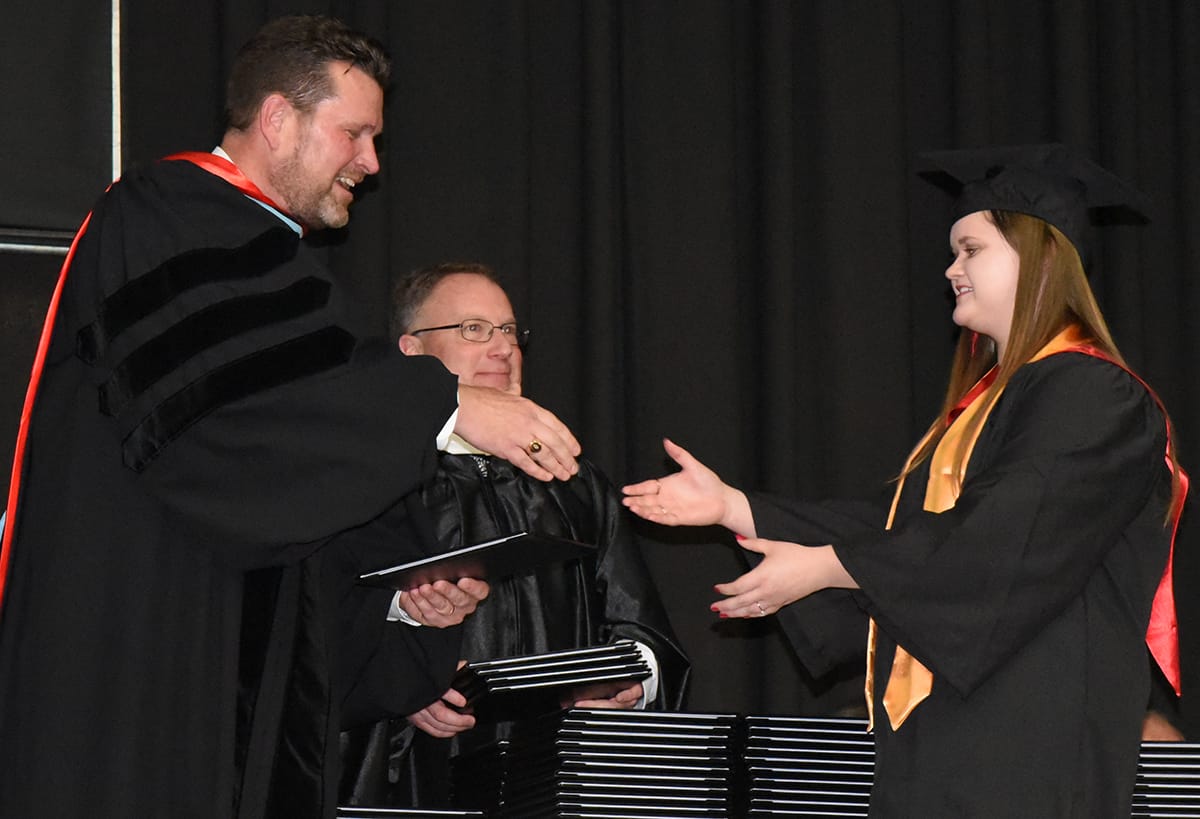SGTC President Dr. John Watford is shown above presenting a diploma to Leah Windham of Oglethorpe, a 2017 Presidential Honor Graduate who earned an associate of applied science in Marketing Management at South Georgia Technical College during the Spring 2017 graduation ceremony.