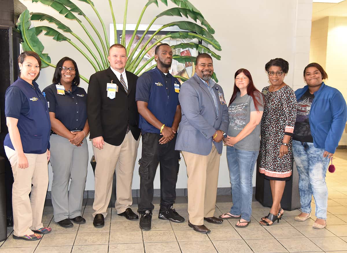 Walmart store Manager John Davis (third from left), Ethics/Compliance Coordinator Paul Thomas (fourth from right), Personnel Coordinator Angelic Holmes (far left), and Walmart associates are pictured with SGTC Director of Career Services Cynthia Carter (second from right) and some of the SGTC students who sat in on the employment opportunity presentation.