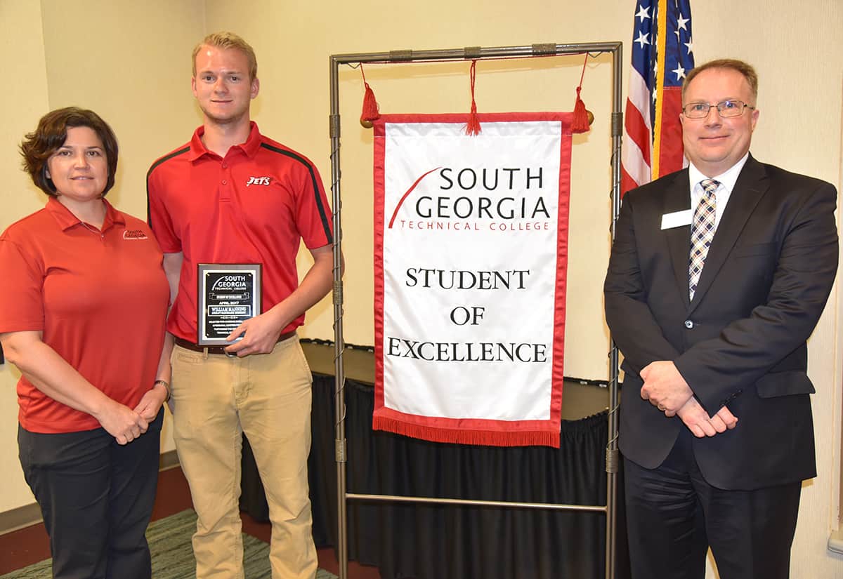 William Manning (center) is pictured with his nominating instructor Victoria Herron and Vice President of Academic Affairs David Kuipers. The Student of Excellence banner will hang in the Aviation Maintenance program area until next month’s Student of Excellence is named.
