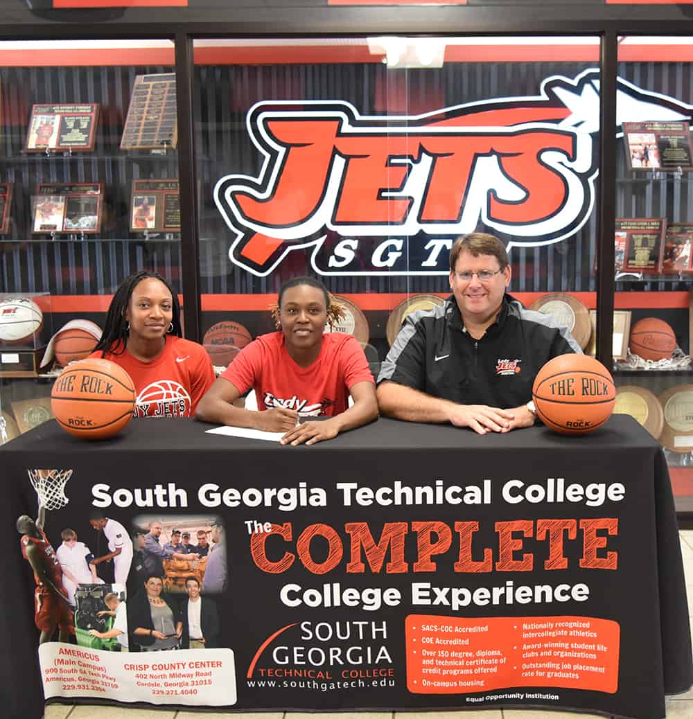 Shaineequah Fluellyn (center) is pictured with SGTC Jets Head Coach James Frey and Assistant Coach Kezia Conyers as she signs her letter of intent to continue her basketball career with USC Aiken.