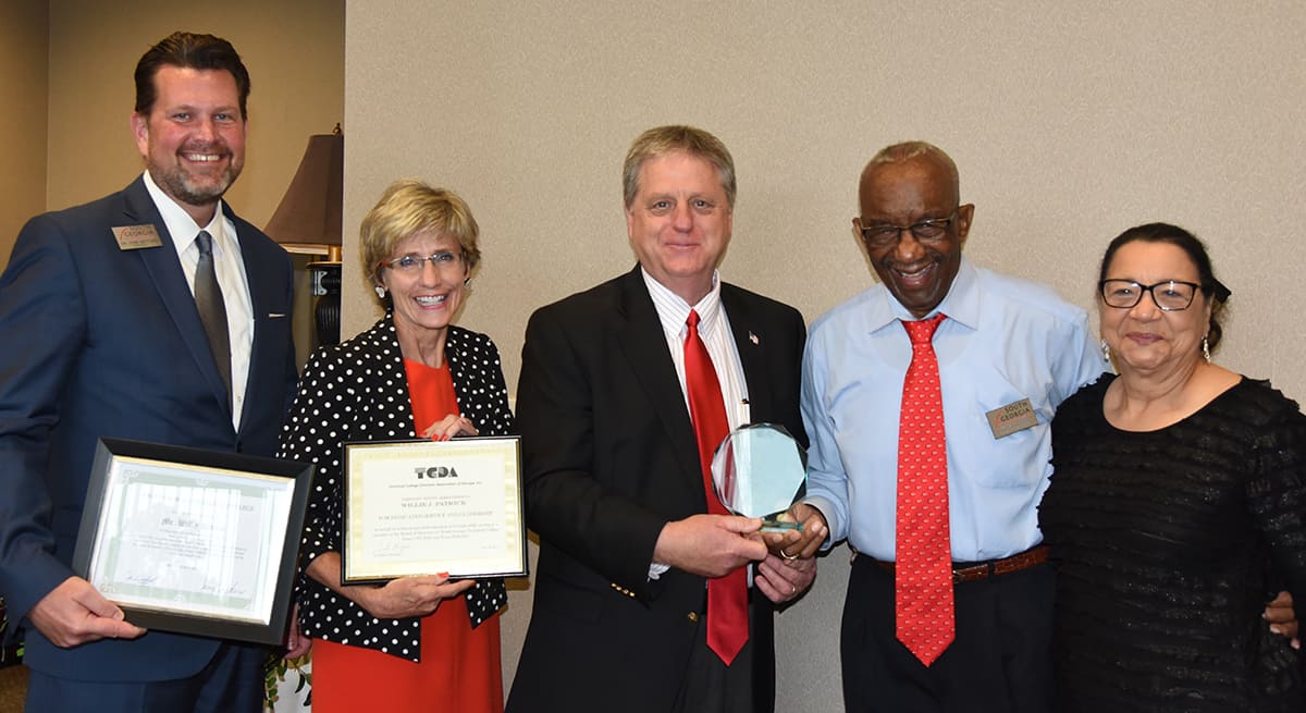 SGTC President Dr. John Watford is shown above (l to r) with Technical College Directors Association Executive Director Adie Shimandle, SGTC incoming Board Chair Richard McCorkle, Willie Patrick and his wife, Dorothy, with the awards and recognition presented to him at the SGTC Board meeting recently.
