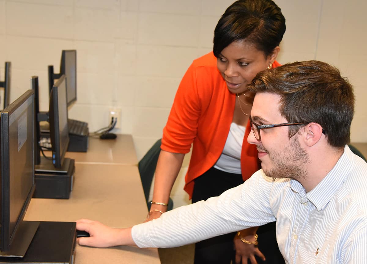 South Georgia Technical College CIS Instructor Andrea Ingram is shown above with student John Beech looking at computer.