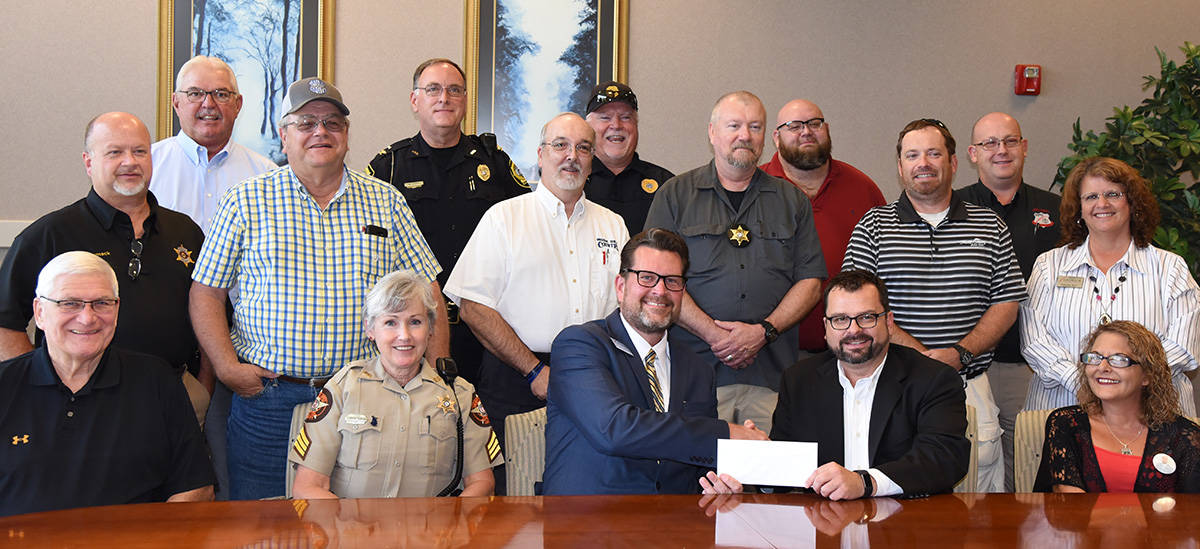 Chad Roberson (seated right center) is shown above presenting SGTC President Dr. John Watford (seated left center) with a scholarship check from the Smarr - Smith Foundation for an endowed scholarship at South Georgia Technical College.