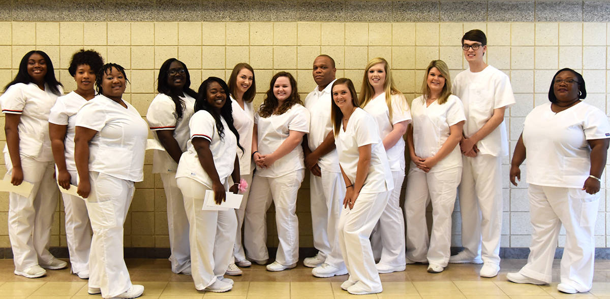 Nursing graduates posing for a picture in hallway