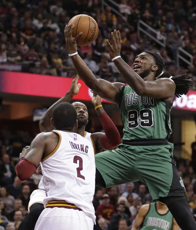 Boston Celtics' Jae Crowder (99) drivers to the basket against Cleveland Cavaliers' Kyrie Irving (2) and LeBron James (23) in the first half of an NBA basketball game Saturday, March 5, 2016, in Cleveland. (AP Photo/Tony Dejak)