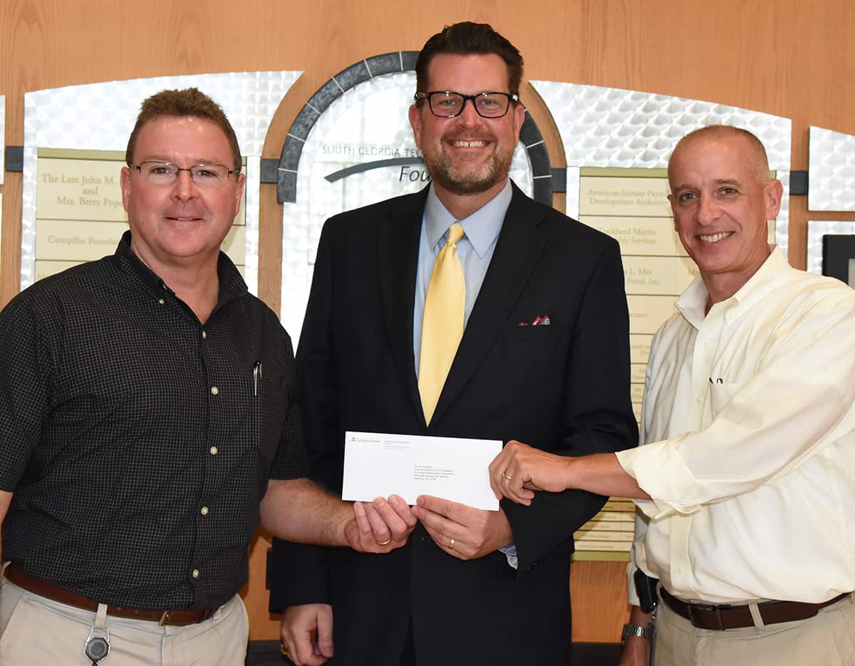 Georgia Power’s Don Porter (l) and Georgia Power Area Manager Jem Morris (r) are shown above presenting South Georgia Technical College President Dr. John Watford (c) with a donation from the Georgia Power Foundation to the SGTC Foundation for the TechForce 2017 annual fund drive.