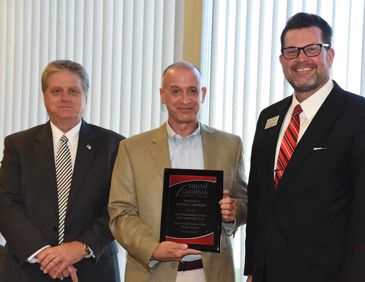 SGTC Board of Directors Richard McCorkle (l) and SGTC President Dr. John Watford (r) are shown above presenting Jem Morris with a plaque recognizing his service to the SGTC Board of Directors. Morris is being transferred out of the Americus area and is resigning his position on the SGTC board.