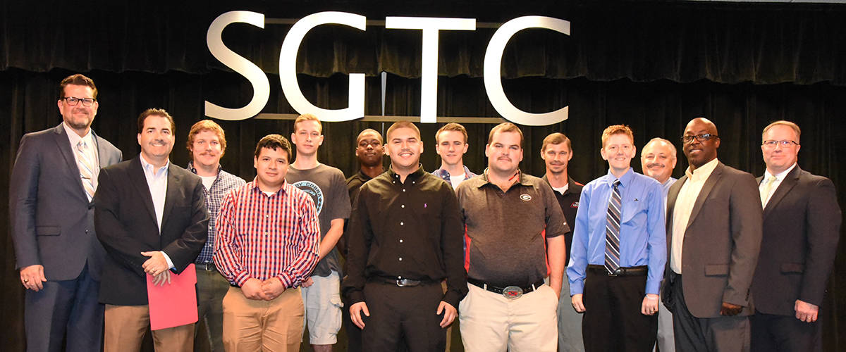 South Georgia Technical College President Dr. John Watford is shown above with Kauffman Tire Vice President Human Relations Theron Garcia and the recent Kauffman Tire graduates from South Georgia Technical College. They are Justin Lynn, Ronny Guzman, Michael McComick, Ja’Qualyn Turner, Bradley Serrano, John Rigdon, Derrick Clinard, and Danny Trulove. Also shown are SGTC Kauffman Tire Instructor Brandon Dean, SGTC Academic Dean Dr. David Finley, Kauffman Tire Region Manager Darrell Russ, and SGTC Vice President of Academic Affairs David Kuipers.