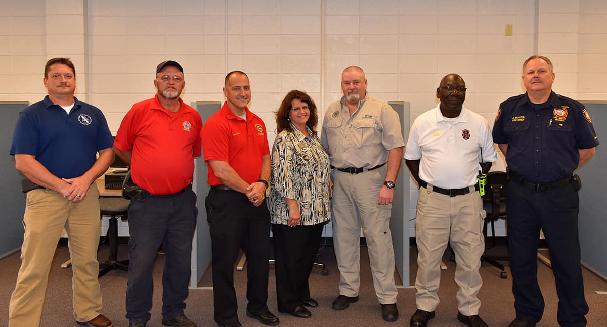 The Fire Science Technology advisory committee stand side by side for a picture.