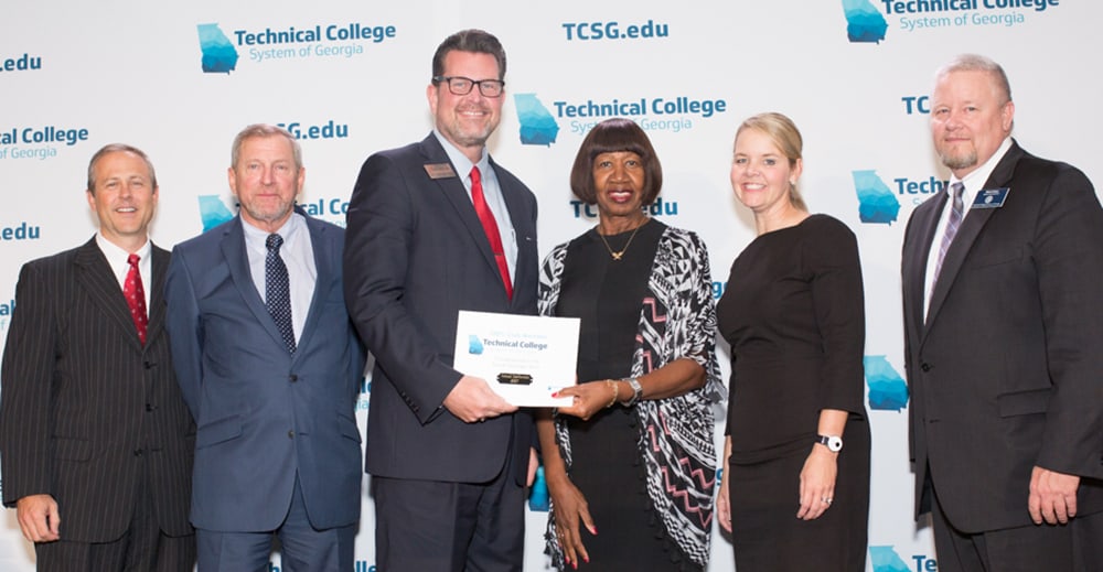 South Georgia Technical College President Dr. John Watford and Board member Janet Siders (c) are shown above with Technical College System of Georgia (TCSG) Commissioner Gretchen Corbin and TCSG Deputy Commissioner Matt Arthur along with TCDA representatives for the SGTC board earning 100% certification for the 2017 year.