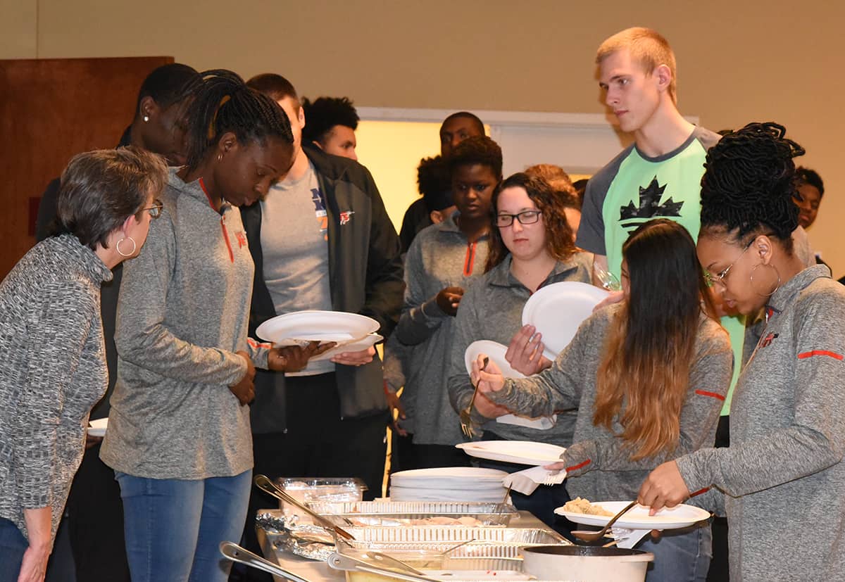 SGTC Lady Jets and Jet are shown above helping themselves to a Thanksgiving Dinner provided by the Jets Booster Club.