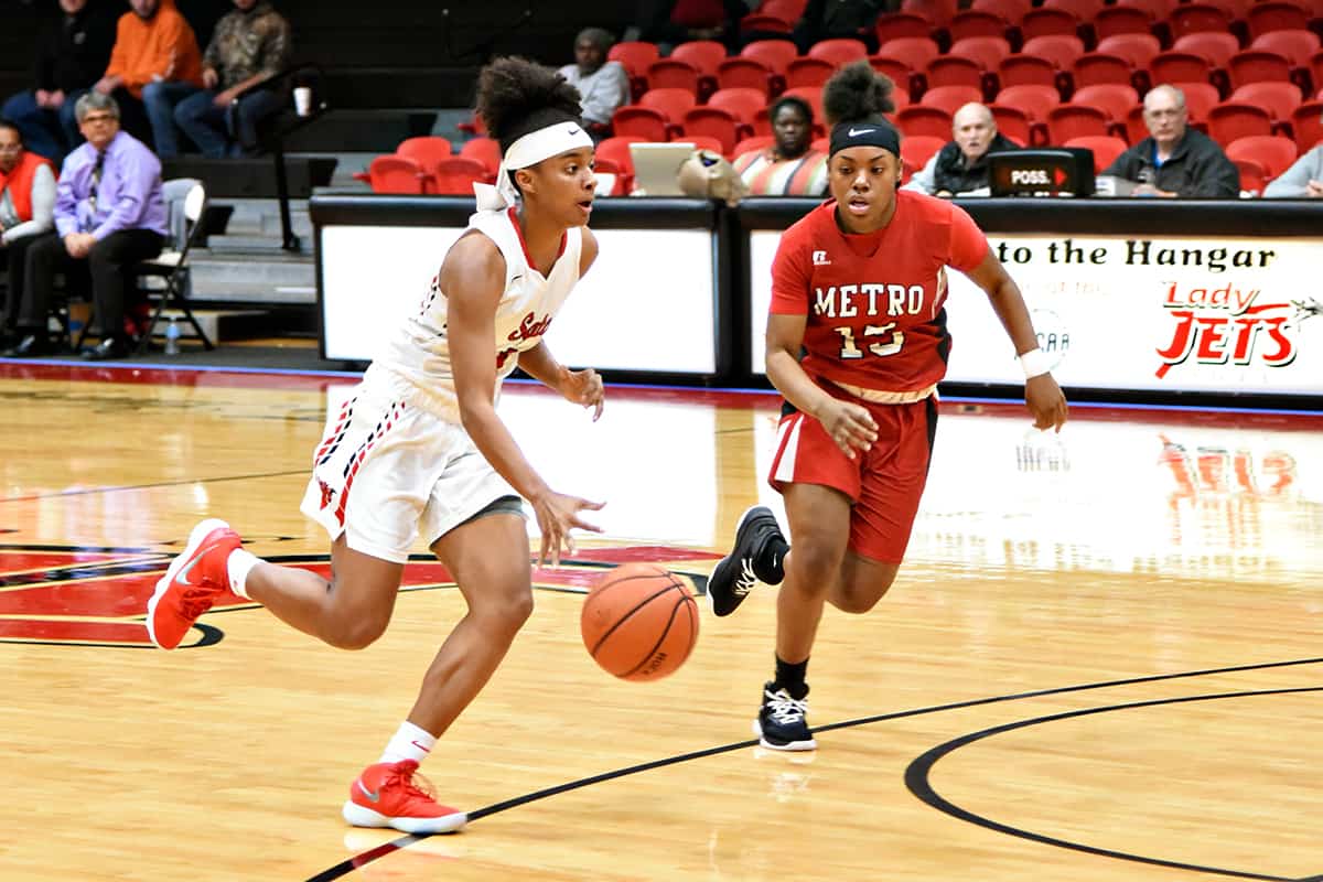 Leading scorer for the South Georgia Technical College Lady Jets Ricka Jackson dribbles the ball past an Atlanta Metropolitan College defender during a recent 90-61 victory.