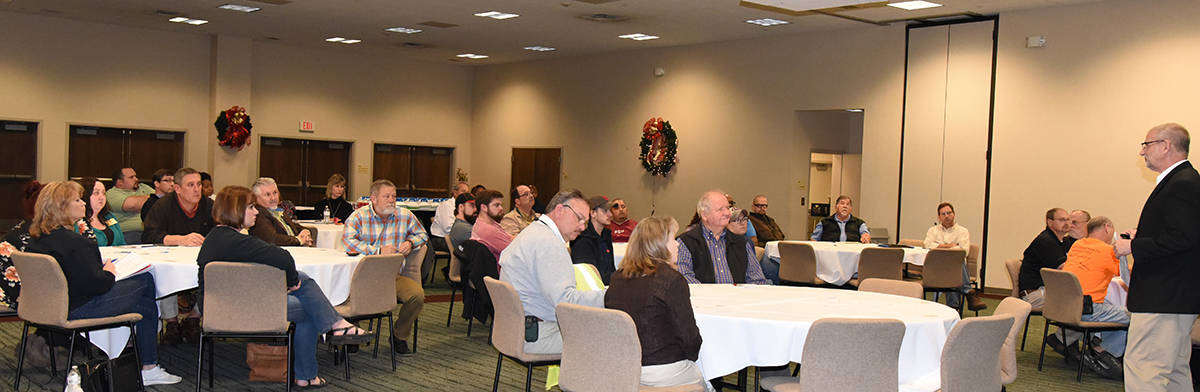 Performance Improvement Advisor Tony Swaim (r) is shown above talking to area business leaders about how to solve problems and improve business opportunities.