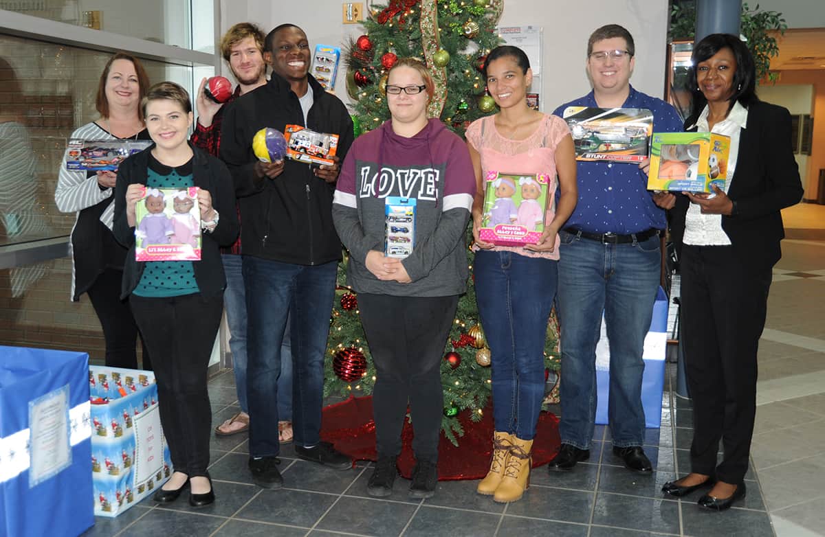 Members of the Student Government Association show off toys that were donated through their Adopt an Angel toy drive. Pictured left to right are Kari Bodrey, Alexandra Joiner, Dakota Hall, Christian Powell, Kelly Wilkerson, Mercedes Rincon, Joshua Chappell and Desiray Kenney.