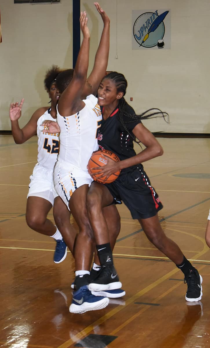 Lady Jets Houlfat Mahouchiza, 5) is shown driving to the basket against Andrew College.