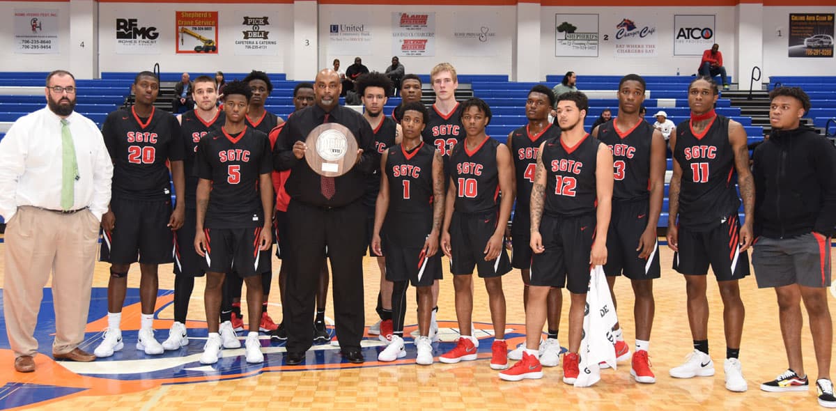 South Georgia Technical College Jets head coach Travis Garrett and assistant coach Chris Ballauer are shown above with the SGTC 2017 – 2018 Jets and the NJCAA Division I men’s basketball Region XVII runner-up trophy after the tournament finals on Saturday in Rome, GA.