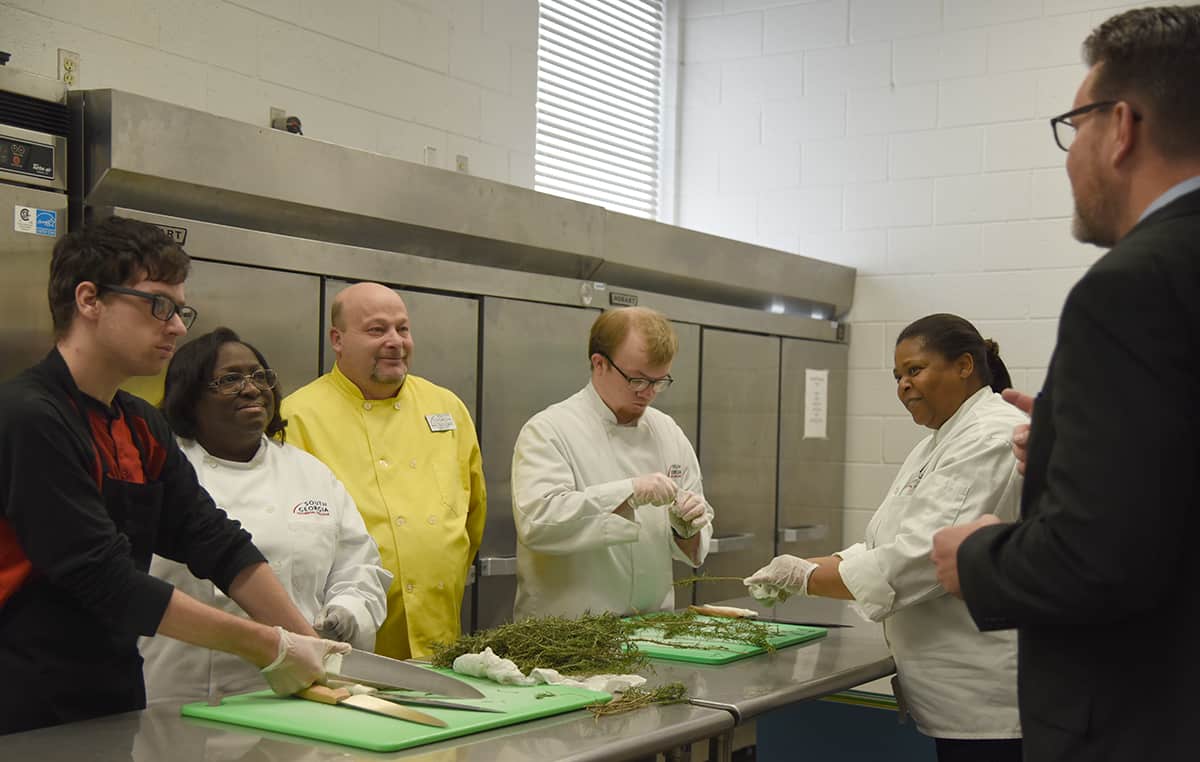 South Georgia Technical College was ranked number one in the nation in Culinary Arts degree programs. Shown above is South Georgia Technical College President Dr. John Watford (right) sharing the good news with SGTC Culinary Arts Instructor Chef Ricky Watzlowick and his students who are preparing rosemary to be used as part of the South Georgia Technical College Foundation Donor Appreciation Dinner. Shown (l to r) are: Tommy Lamaree, Gussie Jackson, Chef Ricky Watzlwick, Ryan Faaborg and Corcynthia Monts with SGTC President Dr. John Watford.