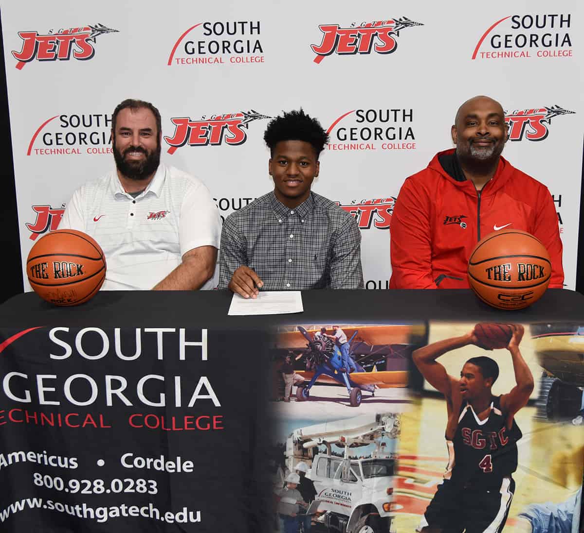 SGTC Guard Mike Boone (C) is shown above signing with Fayetteville State University in North Carolina. SGTC Assistant Jets Coach Chris Ballauer (l) and SGTC Jets head coach Travis Garrett (r) are shown with Boone during the signing process.