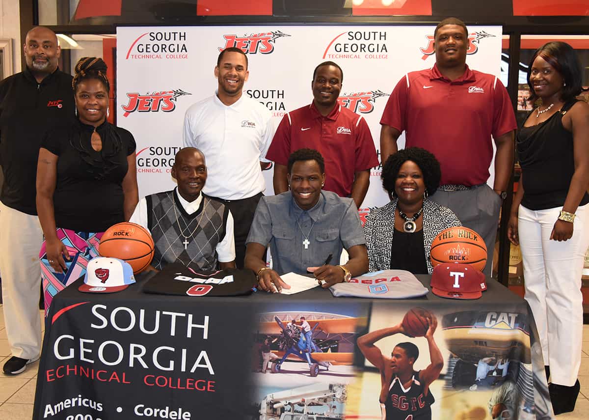 South Georgia Technical College sophomore forward Marquel Wiggins from Oglethorpe, GA signed a national letter of intent to play his junior season with the Talladega College Tornadoes in Talladega, AL. Shown with Marquel Wiggins (seated center) are his step dad, Kerry Wright and his mom, Janice Wright. Also shown are SGTC head coach Travis Garrett, his sisters Twanisia Davis and Maya Leggett along with members of the Talladega Coaching staff, assistant coach Angelo Jones, head coach Fred Summers, and assistant coach Derrick Bails.