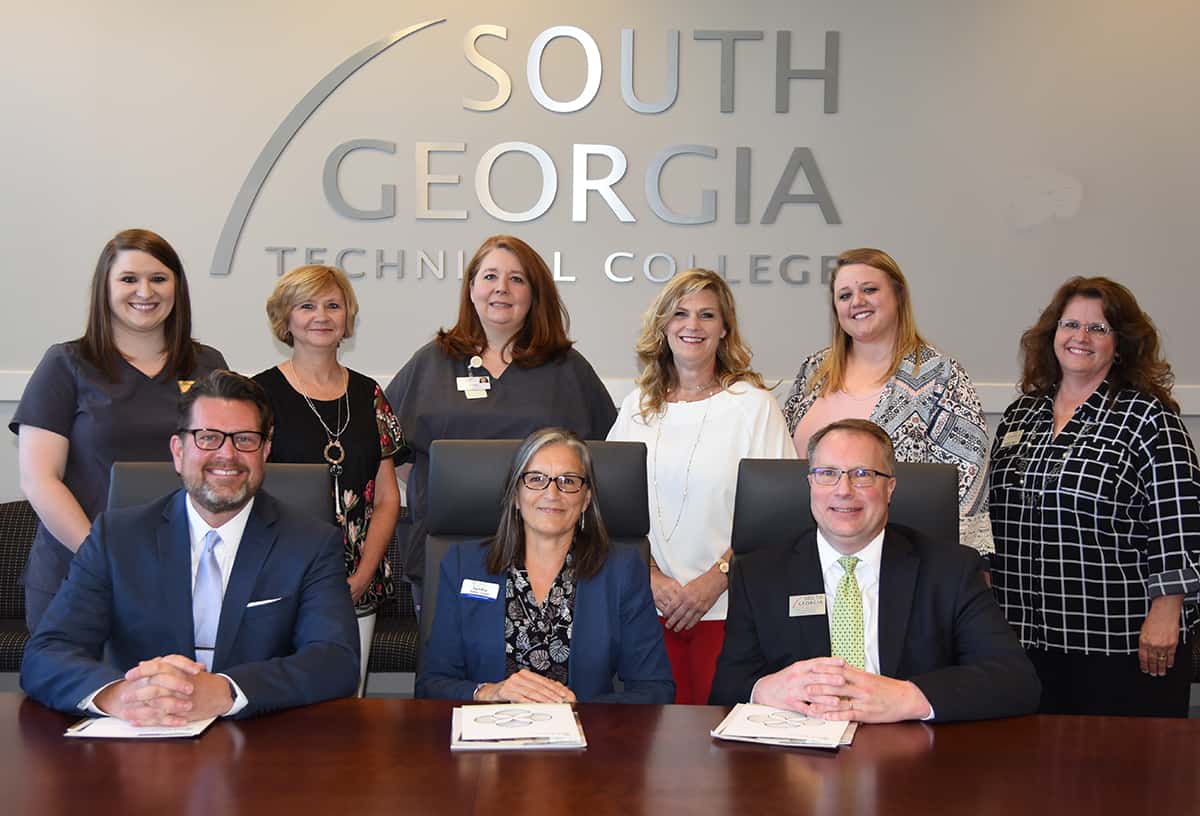 South Georgia Technical College President Dr. John Watford (seated left) is shown above with Sandra Eskew Capps, Director of Academic Relations for CHSGa (seated center) and SGTC Vice President of Academic Affairs David Kuipers during the scholarship presentation. Also shown (standing) are: Melissa Dupree of the Lillian G. Carter Health and Rehabilitation in Plains, Georgia; Debra Mims, Regional Vice President for the Southwest Region, Ethica; Tonya Mathis of the Lillian G. Carter Health