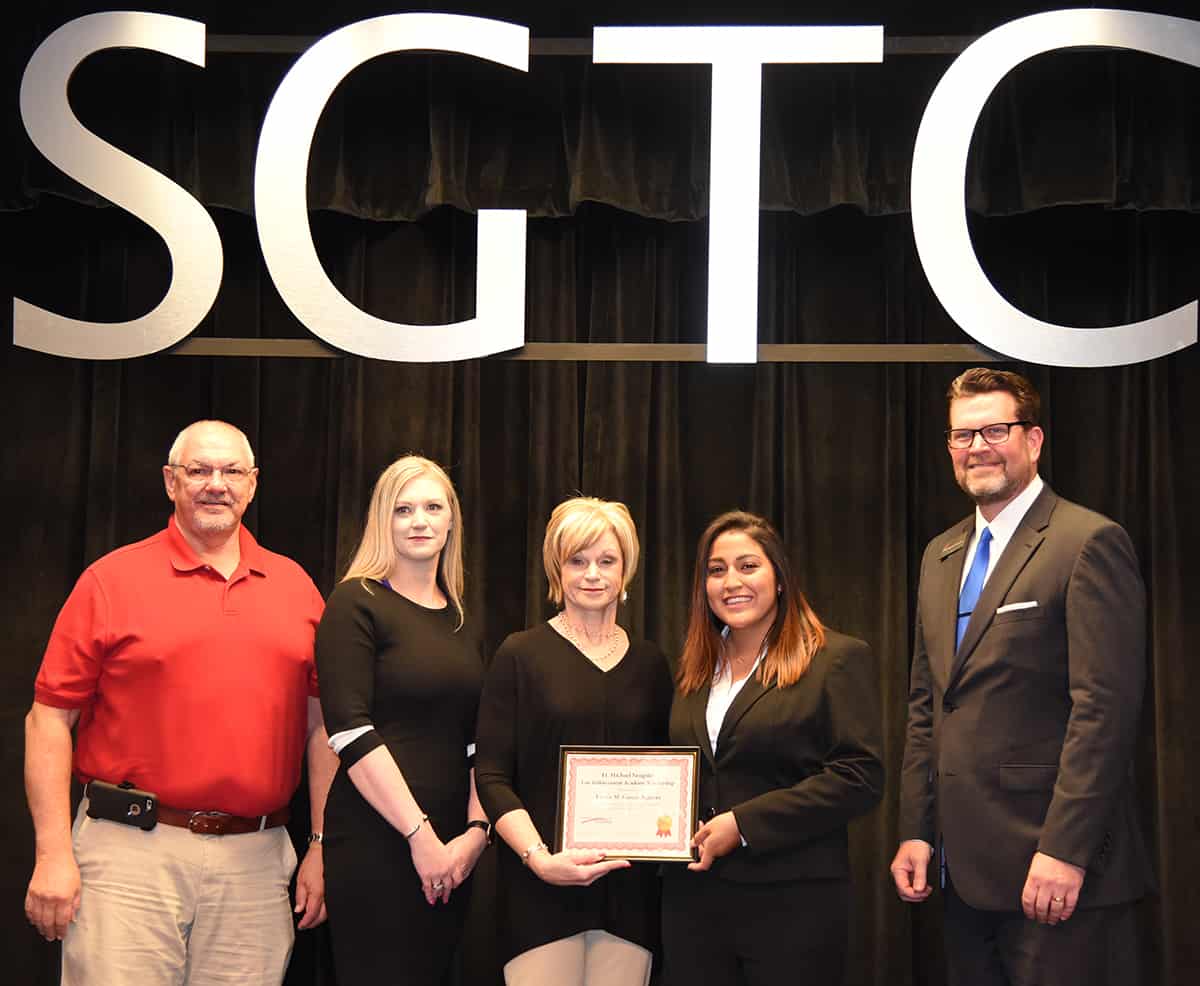 Lt. Michael Sangster’s dad, Robert Sangster, Sr., his sister, Melissa, and his mom, Connie Sangster Youngblood are shown above (l to r) presenting the Lt. Michael Sangster Scholarship award to Vivian Garcia-Aguirre of Americus with South Georgia Technical College President Dr. John Watford looking on during the SGTC Law Enforcement Academy Class 18-01 graduation ceremony.