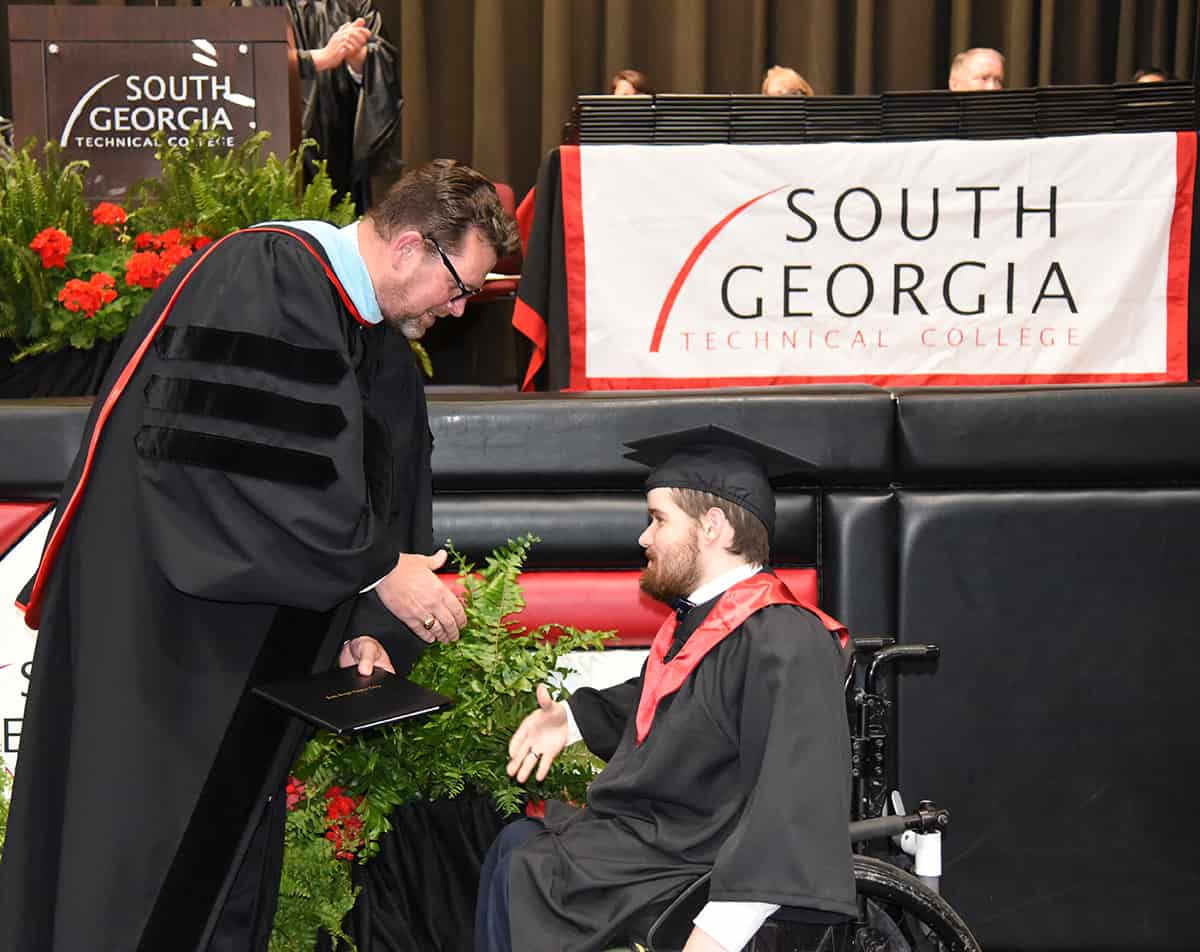 Russell Johnson of Americus is shown above receiving his associate degree in Criminal Justice from SGTC President Dr. John Watford.