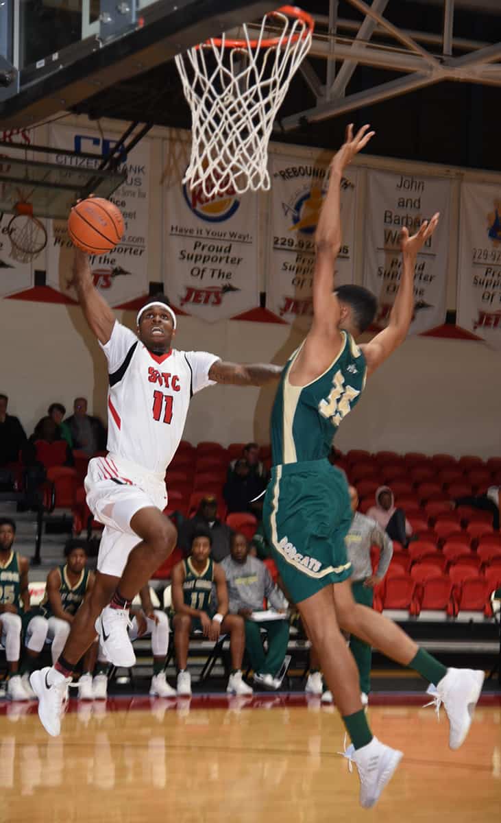 Dawan Bass (11) signs with Rogers State University in Oklahoma.