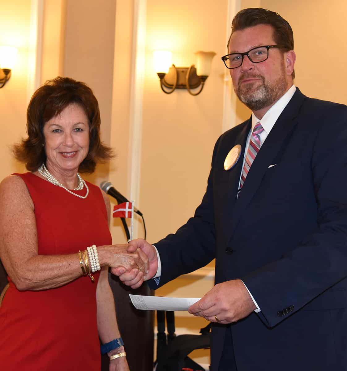 South Georgia Technical College President Dr. John Watford (r) is shown above accepting a donation from Rotary Club of Americus President Gaynor Cheokas (l) for the South Georgia Technical College GED Summer Graduation exercises.