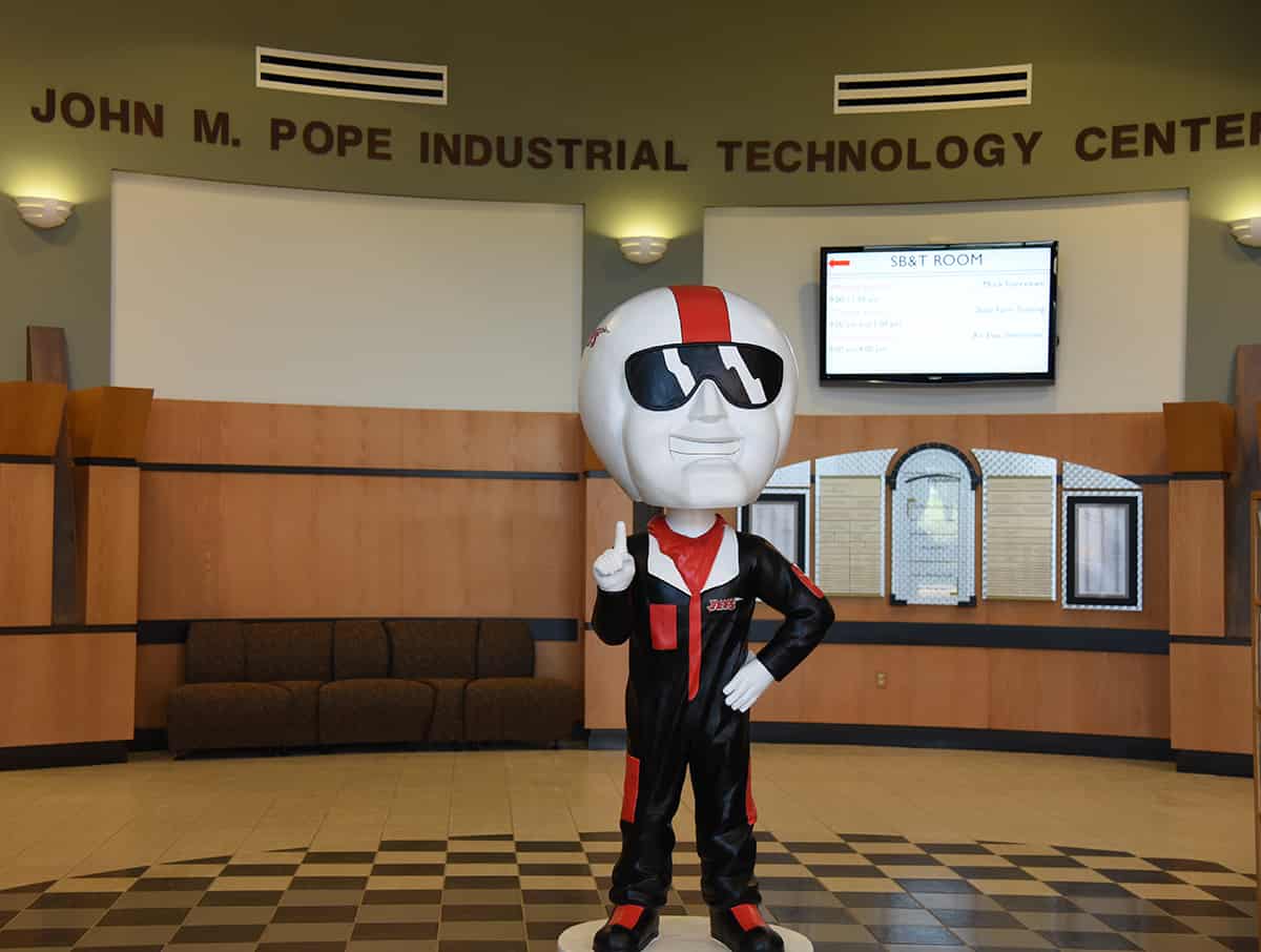 Bobblehead ACE is shown in the rotunda of the John M. Pope Industrial Technology Center.