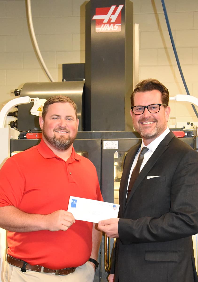 South Georgia Technical College President Dr. John Watford (r) and SGTC Precision Machining and Manufacturing Instructor Chad Brown (l) are shown above with the $10,000 donation to the South Georgia Technical College Foundation. They are shown in front of one of the college’s Haas machines that students train on in the Precision Machining and Manufacturing program.