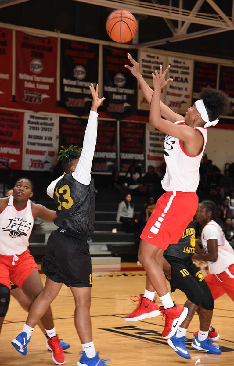 Sophomore forward Ricka Jackson, 1, was the leading scorer for the Lady Jets. She is shown above shooting from the three-point line. She was two of seven from the three point line.