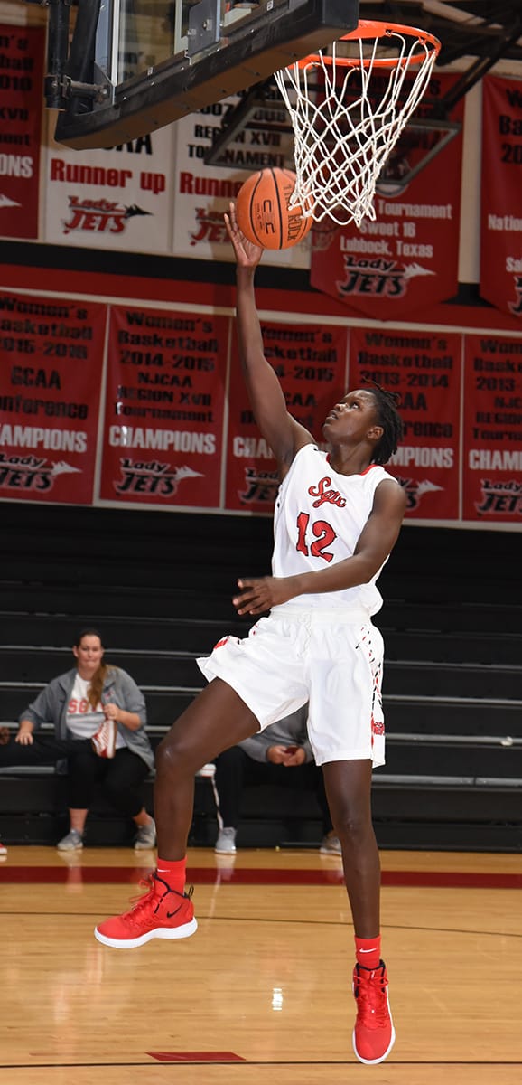 Sophomore forward Fatou Pouye (12) is shown going in for a layup against Wallace State. She led the Lady Jets in scoring with 22 points in that match-up.