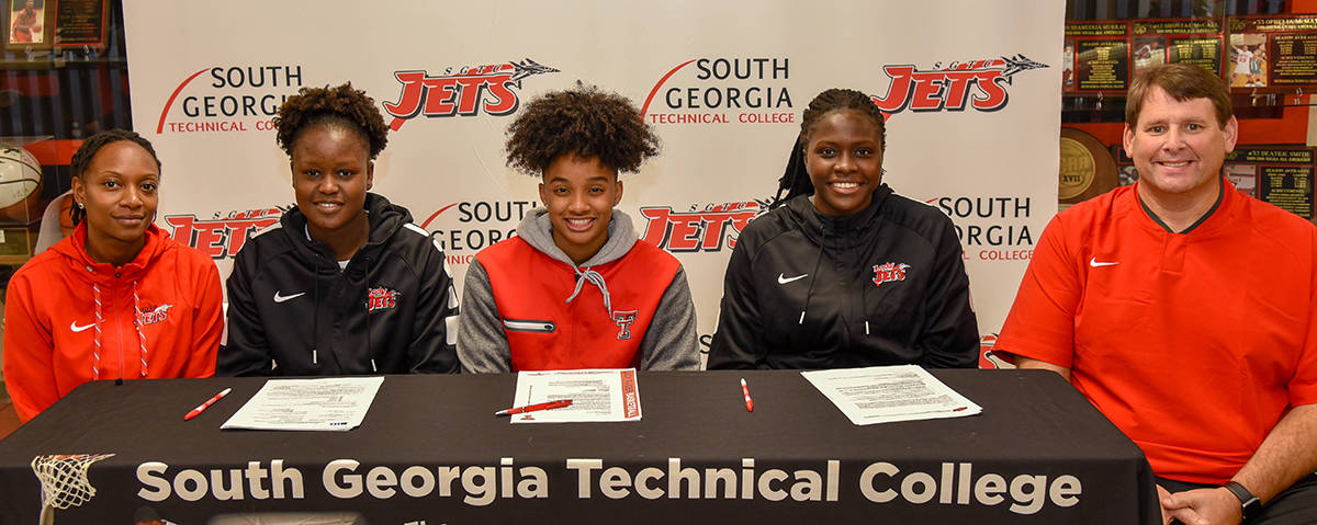 South Georgia Technical College Lady Jets Assistant Coach Kenzia Conyers is shown above with Lady Jets Fatou Pouye, Ricka Jackson, and Bigue Sarr along with South Georgia Technical College Athletic Director and Lady Jets head coach James Frey at the NCAA early signing day event. Pouye signed to play with Illinois at the next level while Jackson chose Texas Tech and Sarr inked with Oklahoma State.