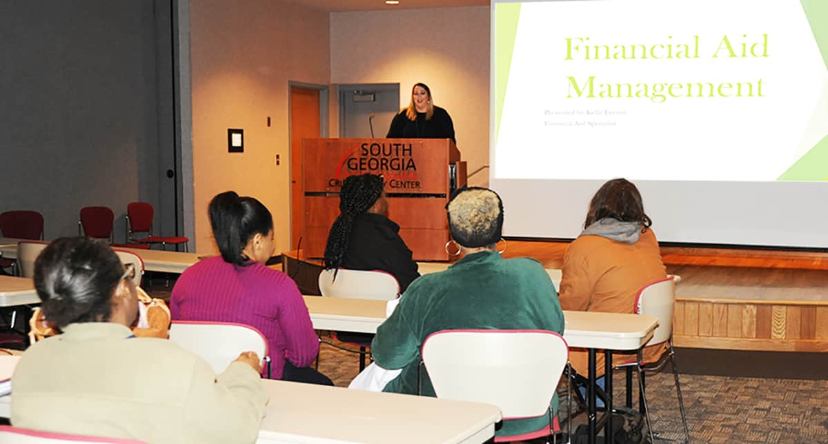 SGTC Financial Aid Specialist Kelly Everett is shown above talking with students at the Financial Aid Management workshop on the Crisp County Center campus recently.