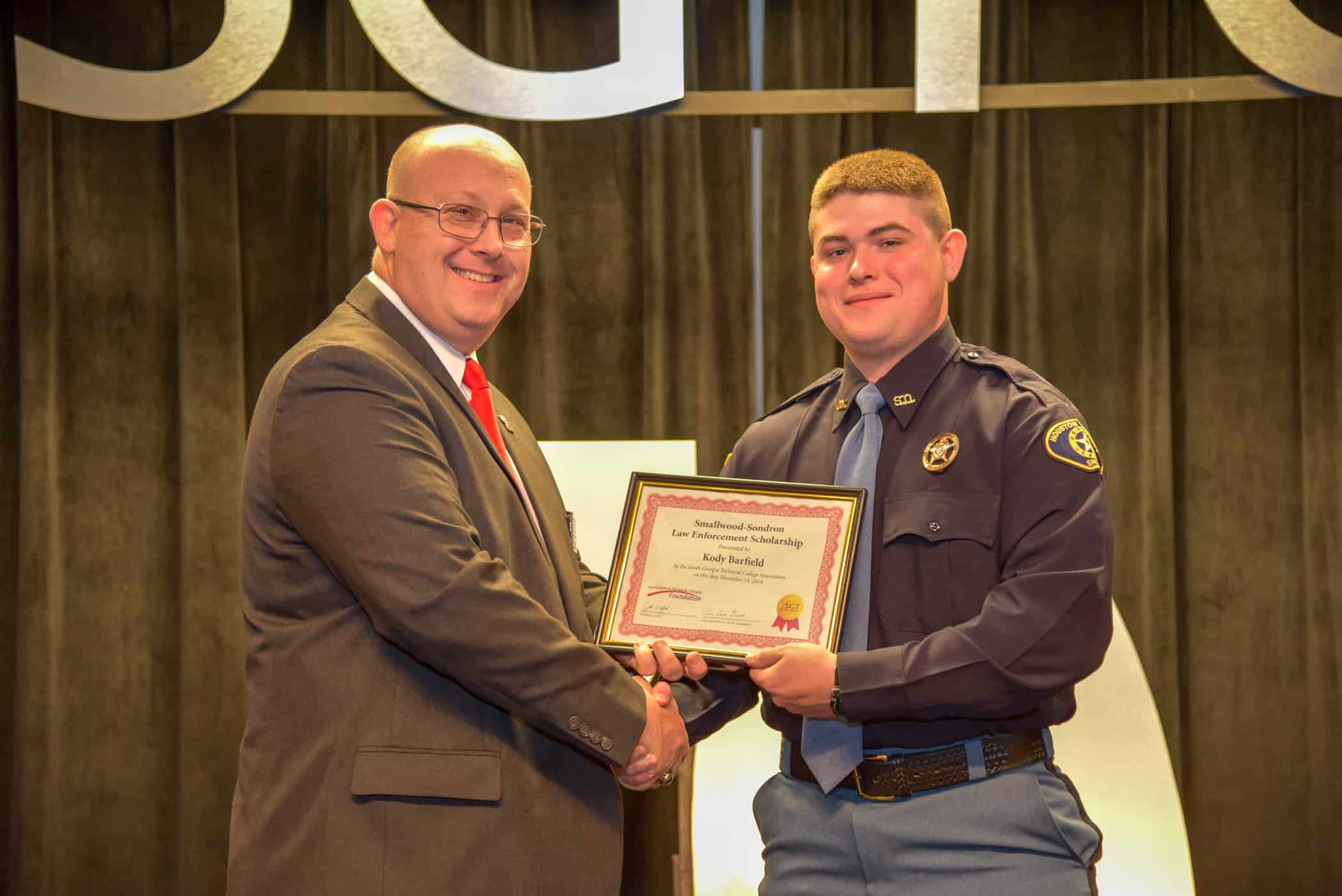 South Georgia Technical College Law Enforcement Academy Director Brett Murray is shown above presenting Kody Barfield with the Smallwood-Sondron Law Enforcement Academy Scholarship.